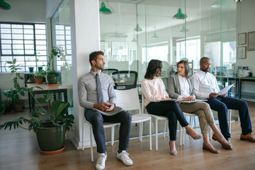 People sitting together in an office waiting for interviews