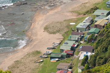Aerial view of fishing houses with solar panels and boats