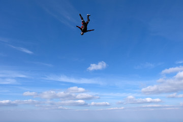 Skydiving. Girl is dancing in the sky.
