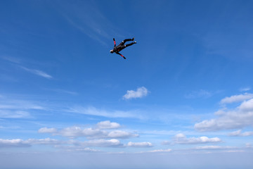 Naklejka na ściany i meble Skydiving. Girl is dancing in the sky.