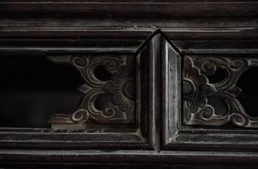 Element of the old dresser close-up. Furniture with wood carving.