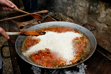 man preparing a typical spanish paella