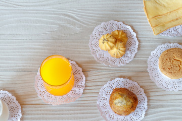 Milk Orange Juice Cookie Banana Cupcake Cupcake and Butter Bread on White Wooden Table