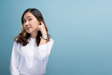 Woman putting a finger into her ear