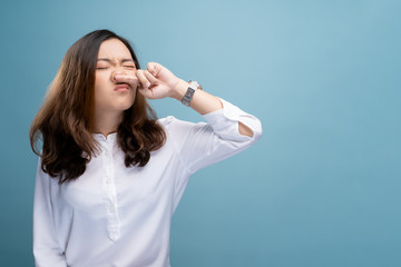 Woman wipe her nose and standing isolated over background