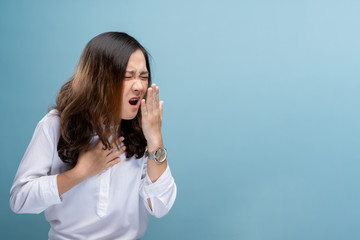 Woman has sore throat isolated over blue background