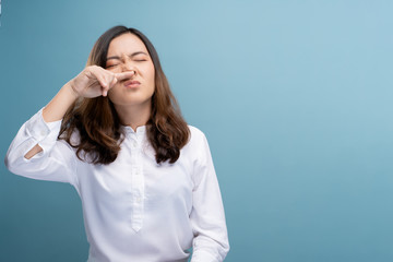 Woman wipe her nose and standing isolated over background - obrazy, fototapety, plakaty