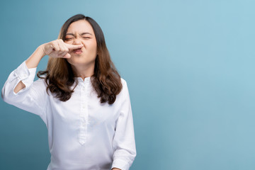 Woman wipe her nose and standing isolated over background