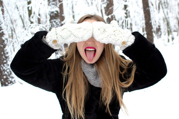 A beautiful young girl with a funny grimace in wintertime