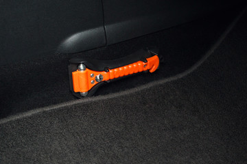 Safety orange hammer in a car .