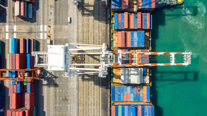Container ship in export and import business logistics and transportation. Cargo and container box shipping to harbor by crane. Water transport International. Aerial view and top view.