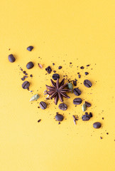 Dry coffee and spices on a yellow background, flat lay.
