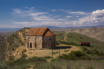 Fototapeta na wymiar medieval orthodox chapel on hilltop of georgian mountain