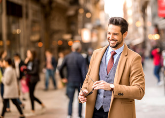 An elegant man walking on the streets