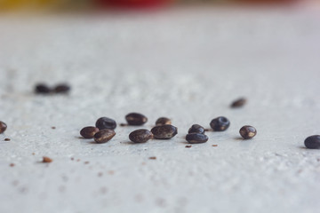 A heap of dried black flower seeds close-up on a white table background. planting season. close up top view copy space