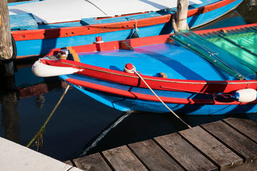 Fototapeta na wymiar blue red boat in harbor of Chioggia (Little Venice), Italy