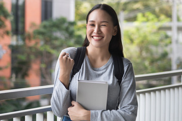portrait of happy, smiling, successful, confident asian woman college student posing guts pose or...