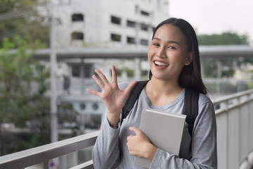 portrait of happy smiling asian woman college student pointing up 5 fingers, five points pose;...