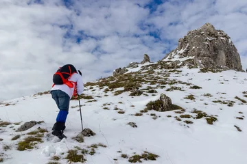 Fotobehang hiker on mountain and snow © Orabona Creative