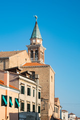 Fototapeta na wymiar tower of San Giacomo church and houses in Chioggioa, Italy 