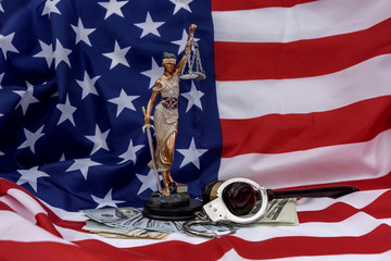 American flag as background for Themis, gavel and dollars