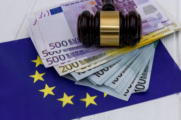 Euro banknotes with judge's gavel and european union flag