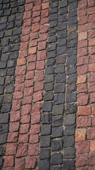 Old cobblestone alleys, roads. Texture of reddish cobblestones pavement. Stock photography