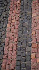 Fototapeta premium Old cobblestone alleys, roads. Texture of reddish cobblestones pavement. Stock photography
