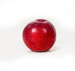 Red juicy apple on a white isolated background. Vegetarian food. Stock photo