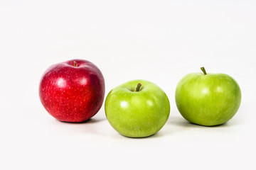 Red and green apples juicy and on a white isolated background. Vegetarian food. Stock photo