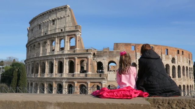 Woman with her daughter admire Roman Colosseum, Rome, Italy