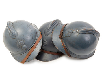 three french military helmets of the First World War on white background