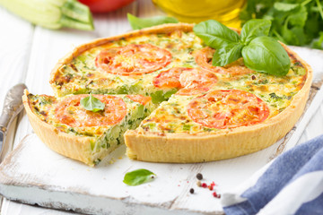Quiche with vegetables (squash, tomatoes, cheese, herbs, green onions), open tart, French cuisine, traditional pastries