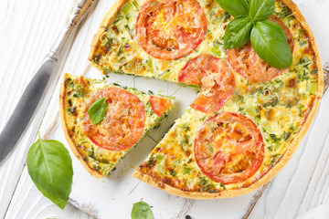 Quiche with vegetables (squash, tomatoes, cheese, herbs, green onions), open tart, French cuisine, traditional pastries