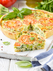 Quiche with vegetables (squash, tomatoes, cheese, herbs, green onions), open tart, French cuisine, traditional pastries