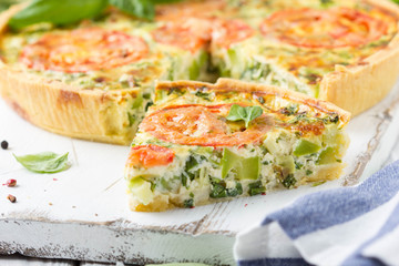 Quiche with vegetables (squash, tomatoes, cheese, herbs, green onions), open tart, French cuisine, traditional pastries