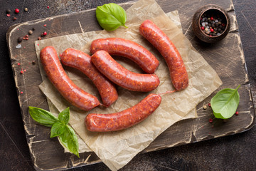 Raw grilled sausages with meat (beef, pork, lamb) and spices, hot merguez, kabanos, chorizo. Delicious food for picnic - obrazy, fototapety, plakaty