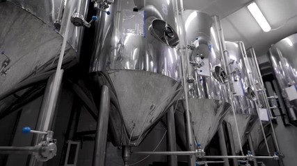 camera is moving along shine modern tank for mashing malt for brewing beer in brewery plant