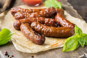Grilled sausages with meat (beef, pork, lamb) and spices, hot merguez, kabanos, chorizo. Delicious fried food for picnic