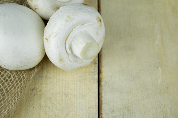 Champignon mushrooms on wooden background