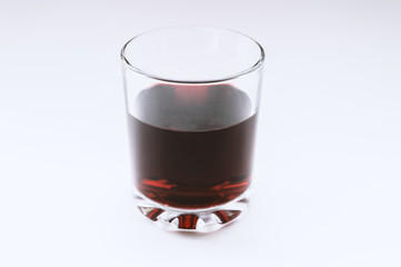 Wine in a glass on light background. Selective focus.