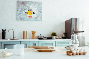 interior of light modern kitchen with bakery ingredients on table