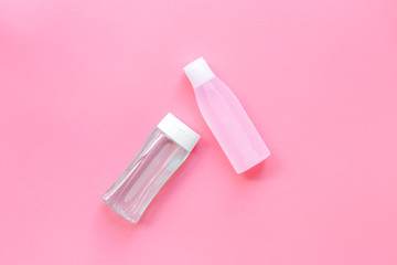 Organic cosmetics for face clearing with facial tonic and mycelial water on pink background top view copy space