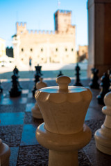 close up of chess piece in old medieval italian town of Marostica in Veneto region with medieval castle and main square in background © davide bonaldo