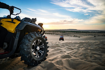 Summer offroad adventure on atv in sand quarry. Entertainment of tourists in desert in MUI ne in Vietnam. Off-road ATV wheel close-up © diy13