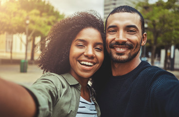 Beautiful happy couple taking selfie self-portrait