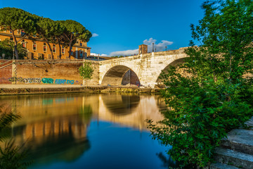 Fototapeta premium Isola Tiberina, Island, River, Tevere, Bridge, Rotto, Cestio, Trastevere district, Basilica of St. Bartholomew on the Island, Roma, Lazio, Italy, Europe