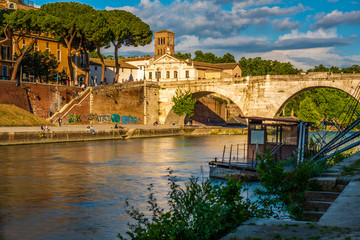 Fototapeta premium Isola Tiberina, Island, River, Tevere, Bridge, Rotto, Cestio, Trastevere district, Basilica of St. Bartholomew on the Island, Roma, Lazio, Italy, Europe