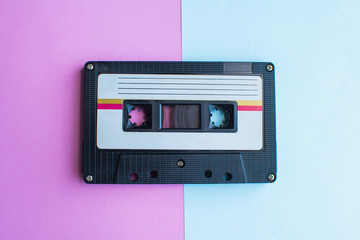 retro of tape cassette on blue and pink background. soft focus.
