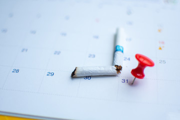 red pin on calendar 31 May (World No Tobacco Day concept) subject is blurred.